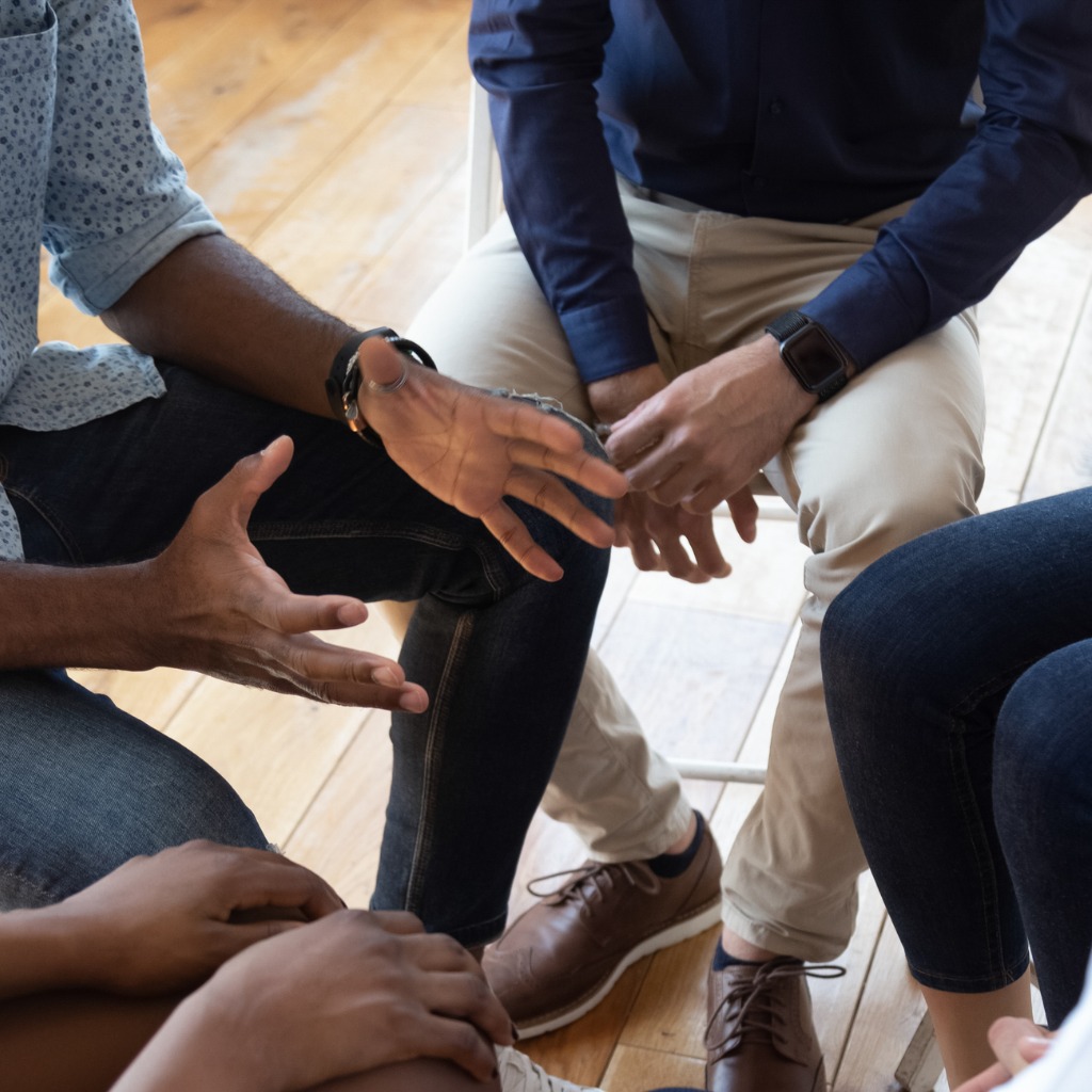 Hands - group counseling therapy session @istockphoto.com/fizkes